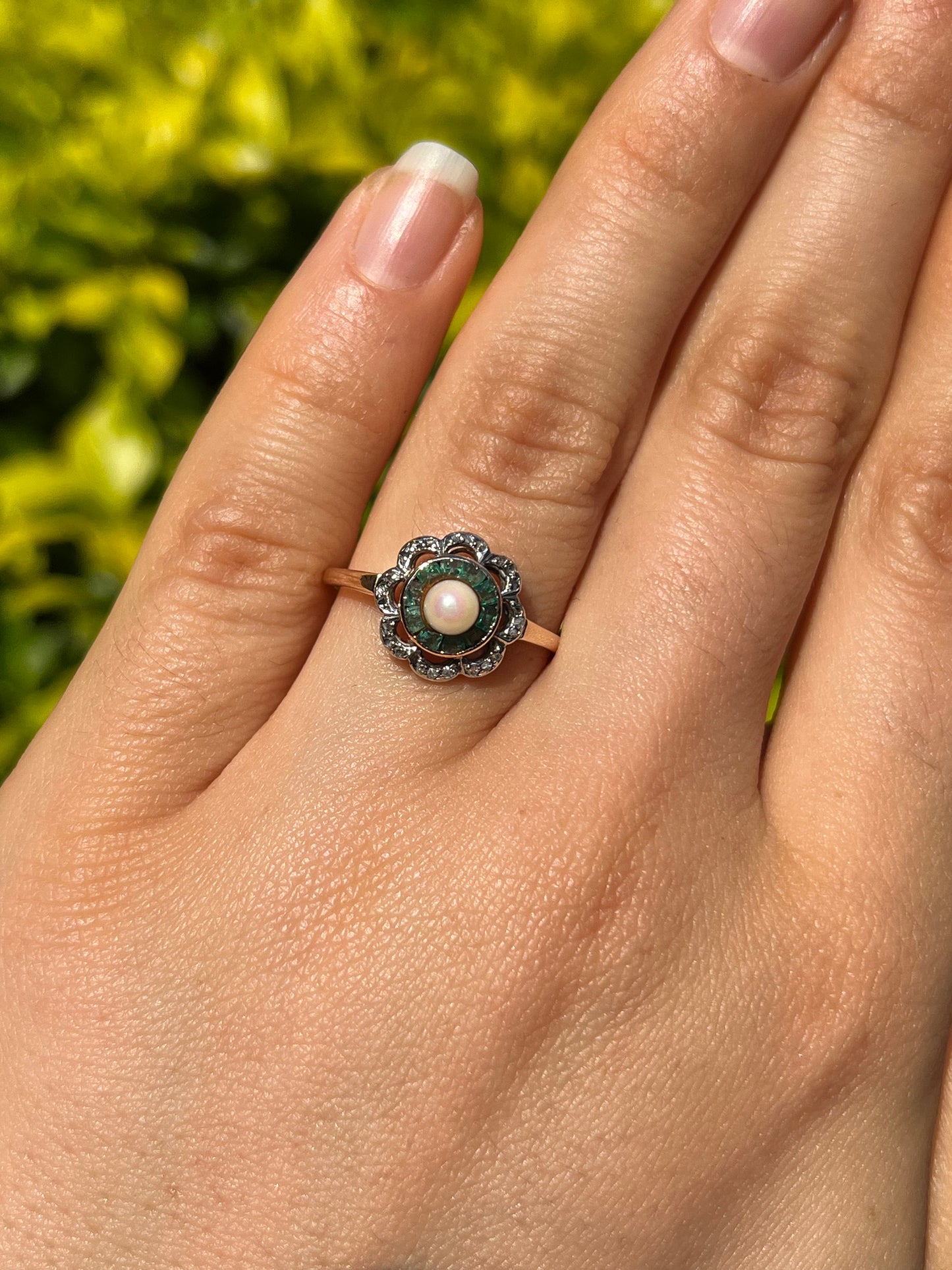 9K gold Edwardian pearl, emerald, and diamond flower ring, circa 1905.