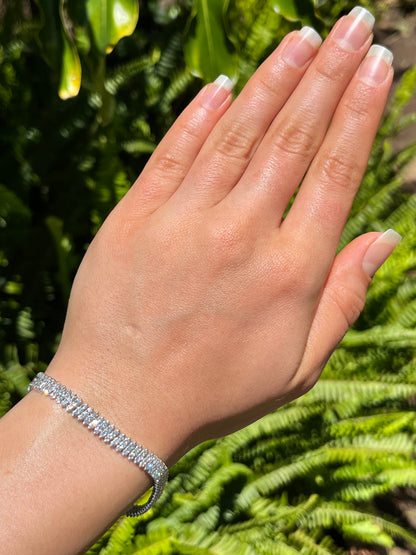 18K gold triple row diamond tennis bracelet.