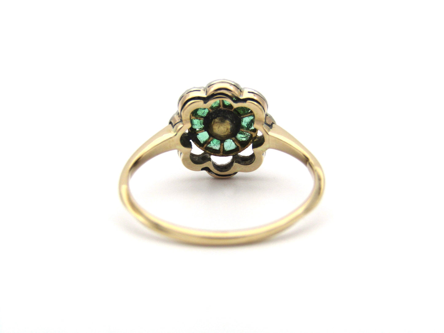 9K gold Edwardian pearl, emerald, and diamond flower ring, circa 1905.