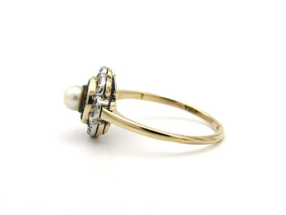 9K gold Edwardian pearl, emerald, and diamond flower ring, circa 1905.