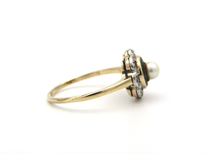 9K gold Edwardian pearl, emerald, and diamond flower ring, circa 1905.