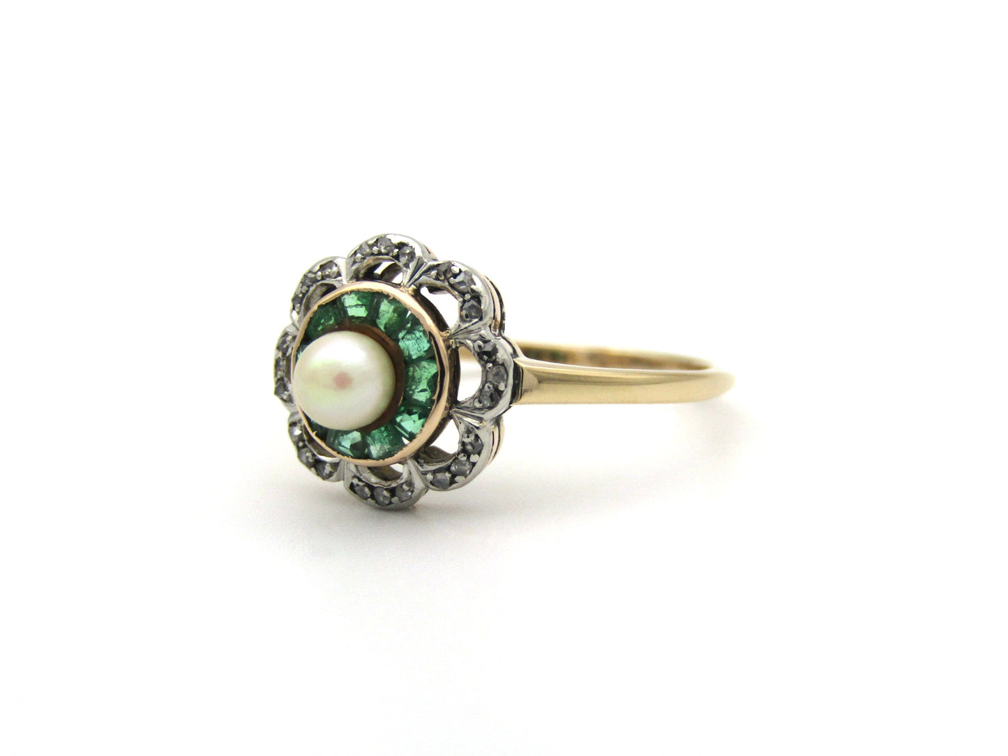 9K gold Edwardian pearl, emerald, and diamond flower ring, circa 1905.