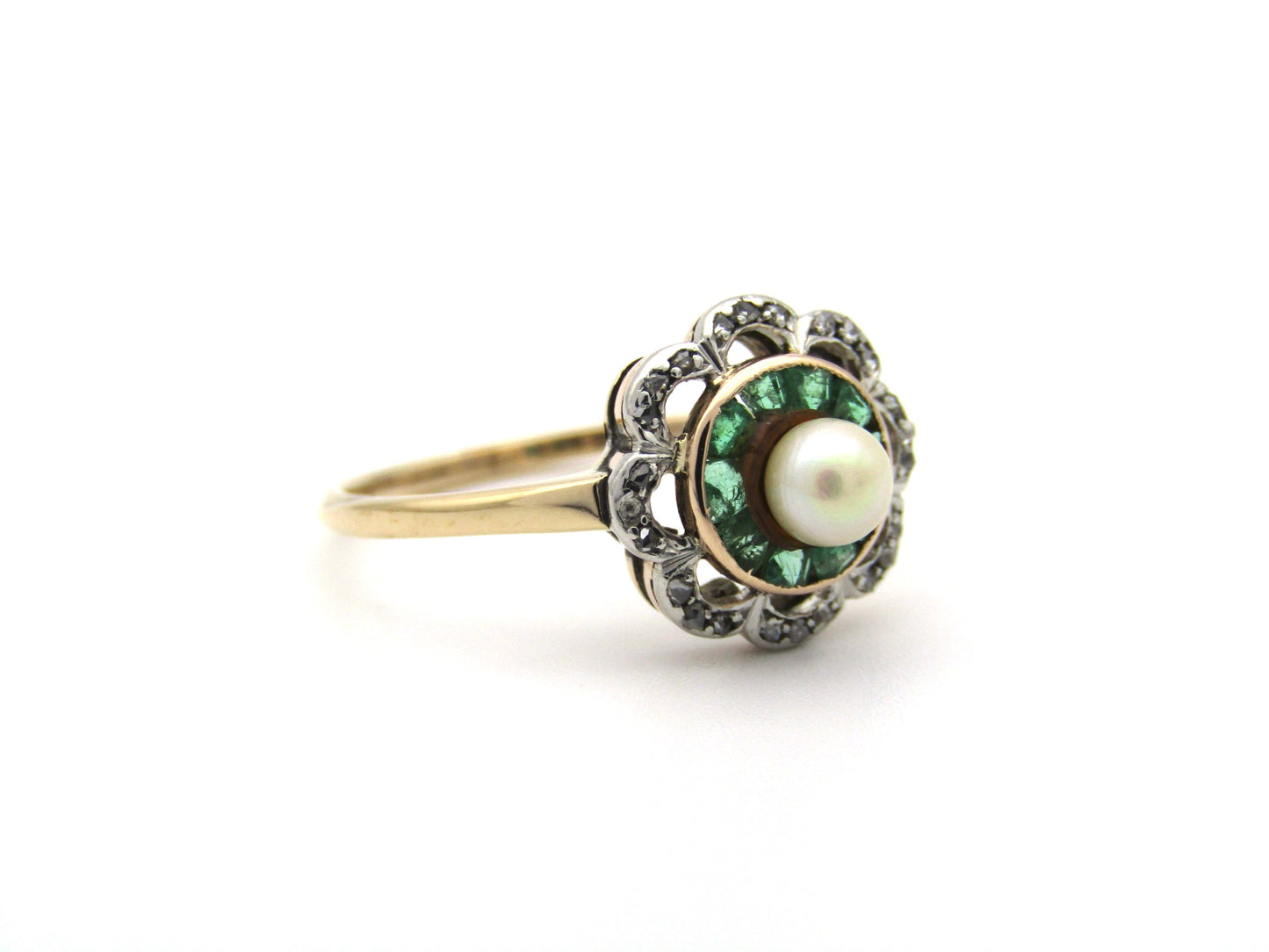 9K gold Edwardian pearl, emerald, and diamond flower ring, circa 1905.