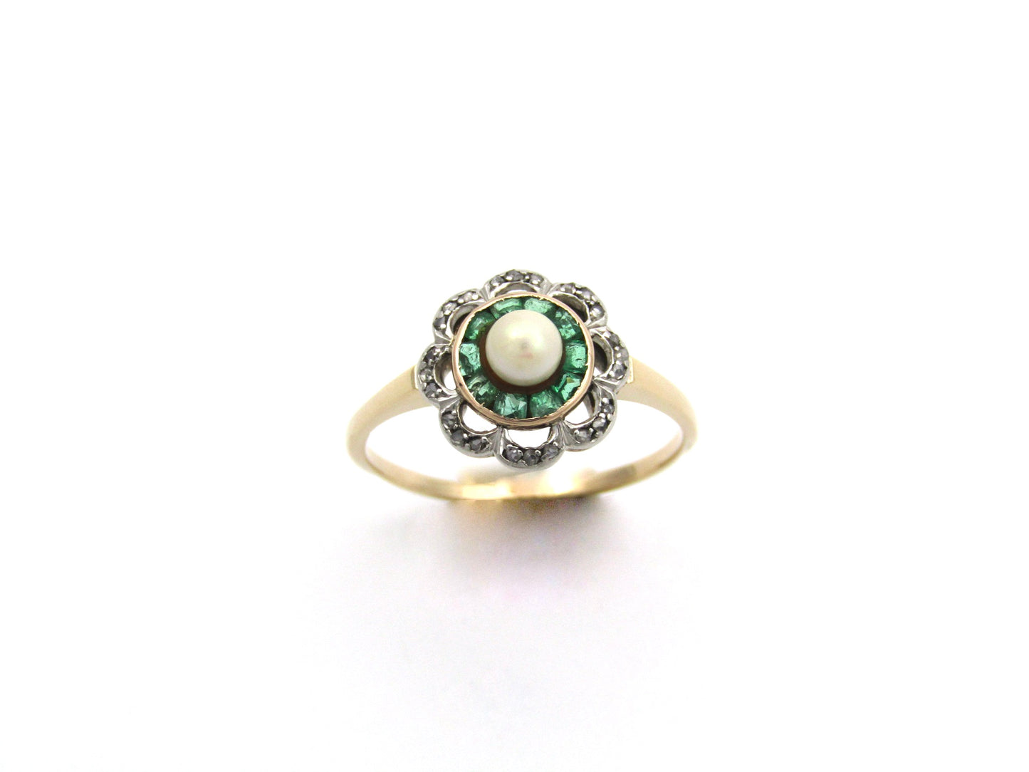 9K gold Edwardian pearl, emerald, and diamond flower ring, circa 1905.