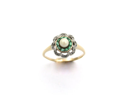 9K gold Edwardian pearl, emerald, and diamond flower ring, circa 1905.