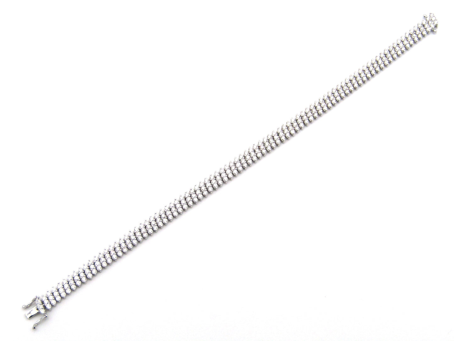 18K gold triple row diamond tennis bracelet.