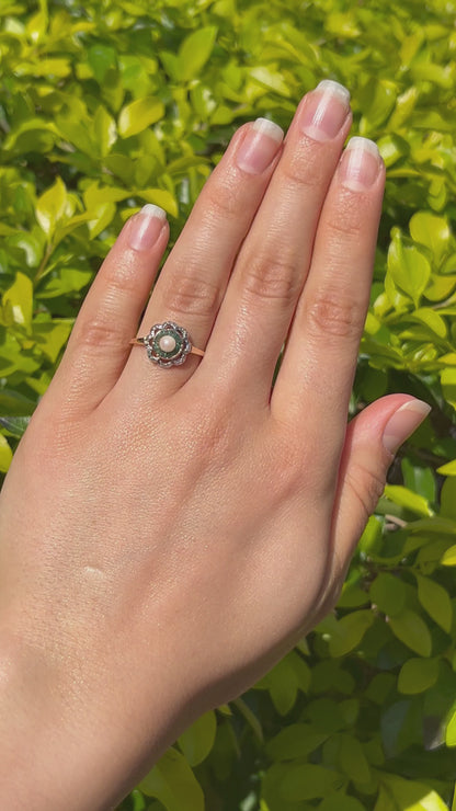 9K gold Edwardian pearl, emerald, and diamond flower ring, circa 1905.