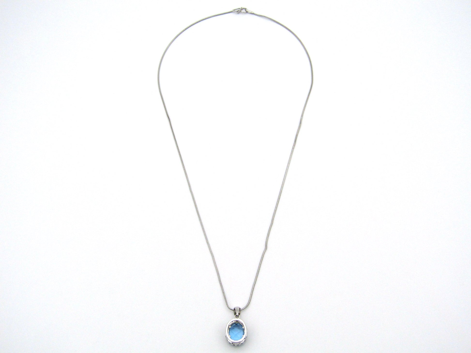 9K gold blue topaz and diamond pendant.