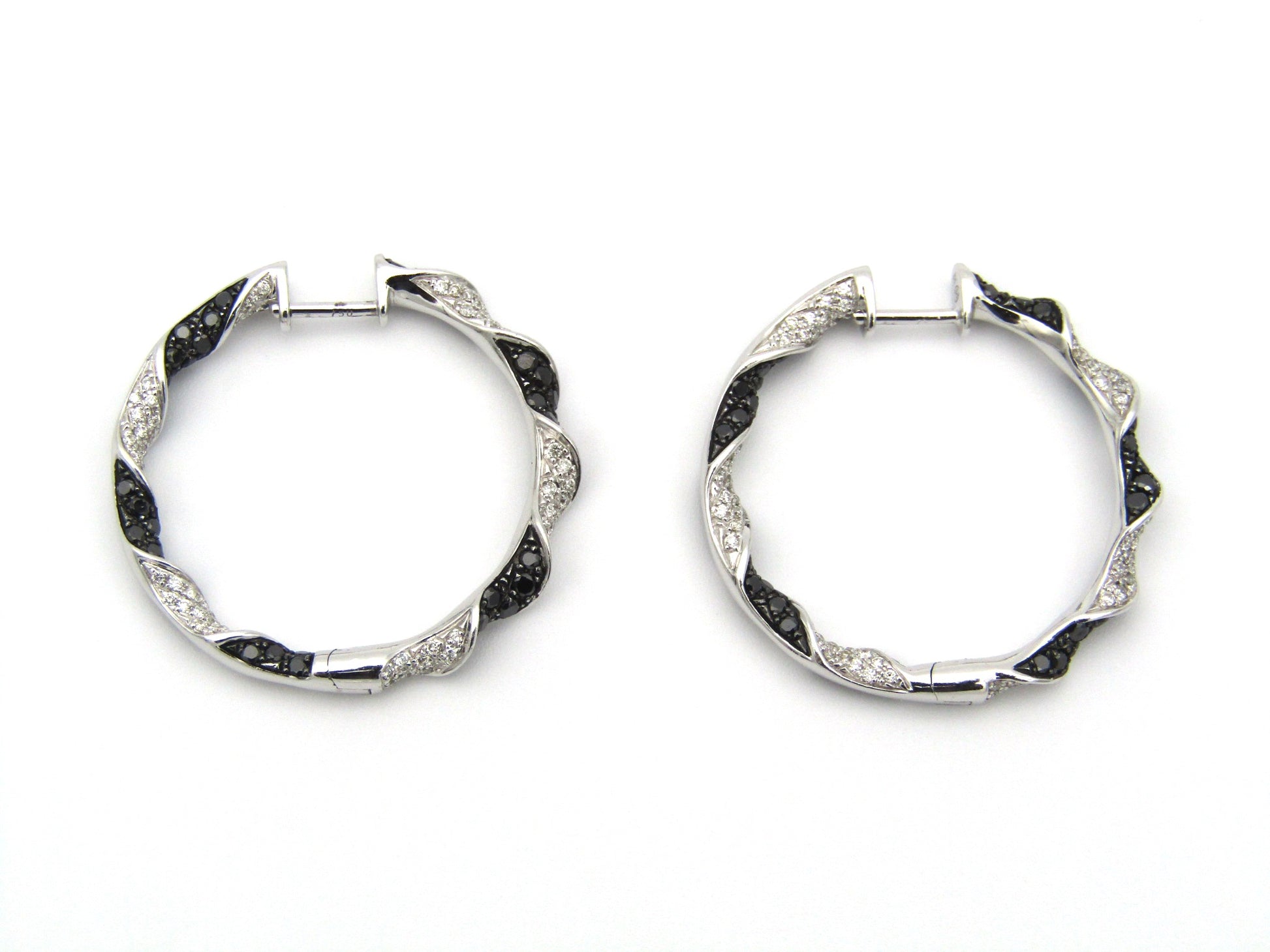 18K gold black and colourless diamond earrings.