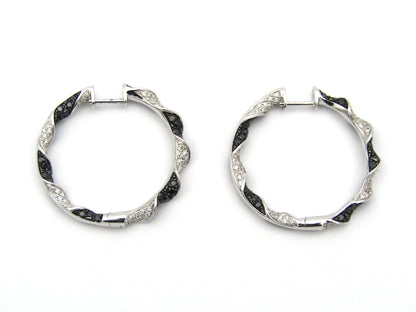 18K gold black and colourless diamond earrings.