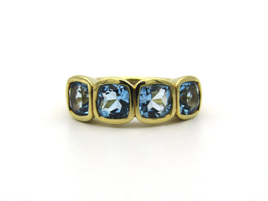 18K gold blue topaz ring.