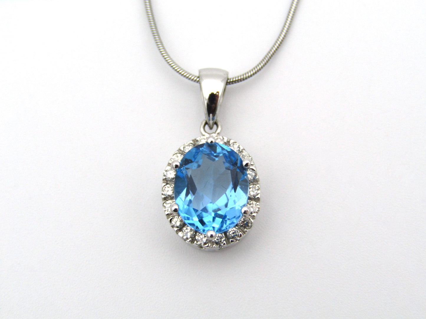 9K gold blue topaz and diamond pendant.