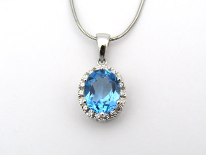 9K gold blue topaz and diamond pendant.
