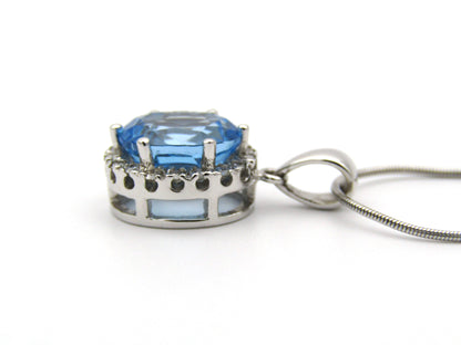 9K gold blue topaz and diamond pendant.
