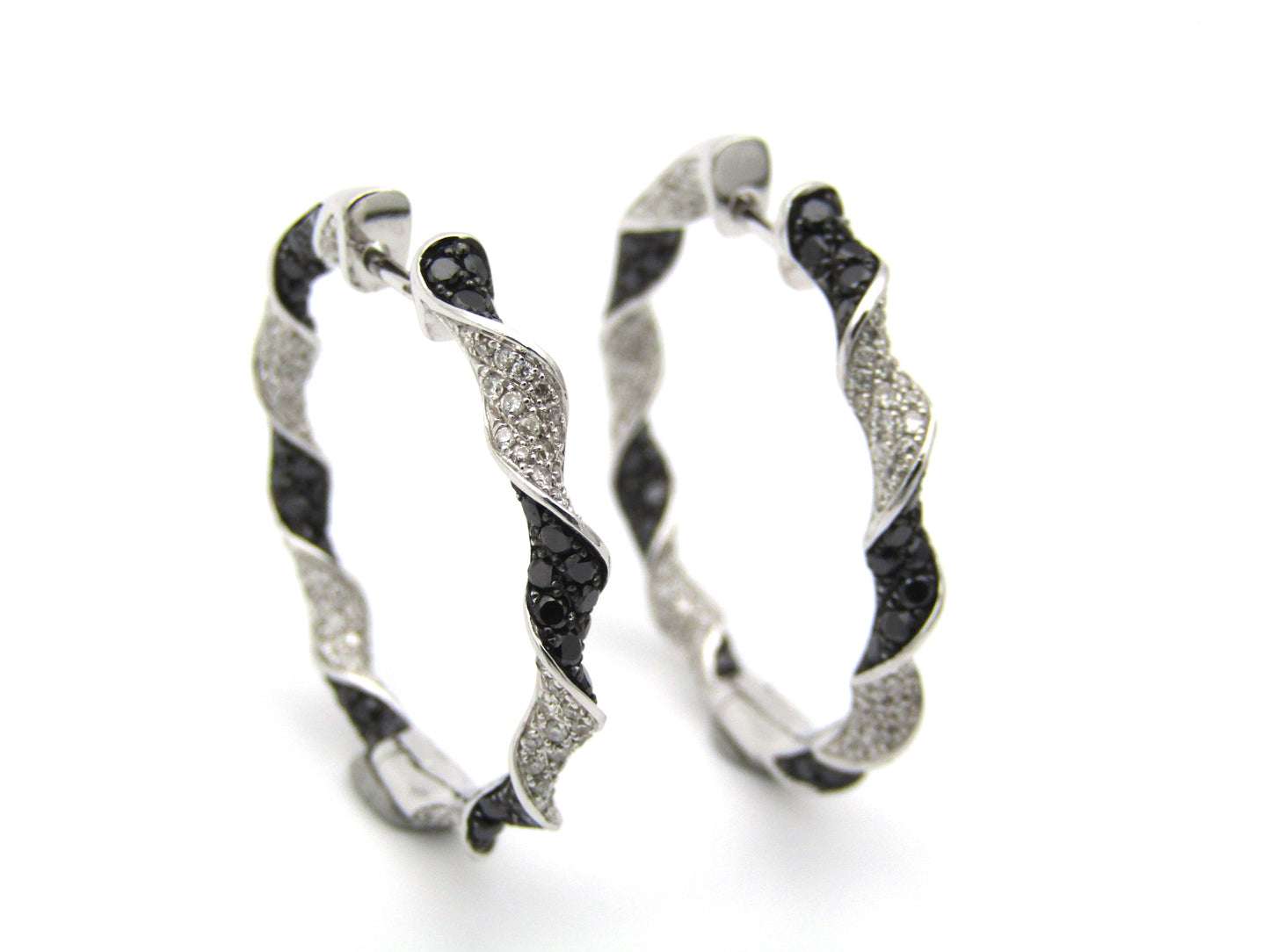 18K gold black and colourless diamond earrings.