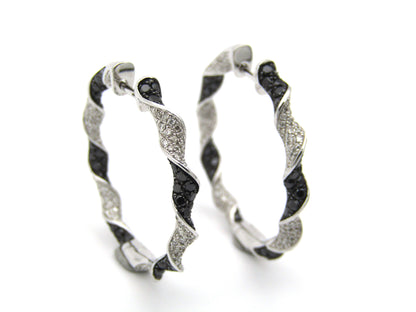 18K gold black and colourless diamond earrings.