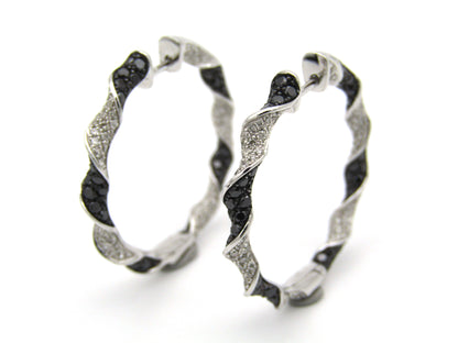 18K gold black and colourless diamond earrings.