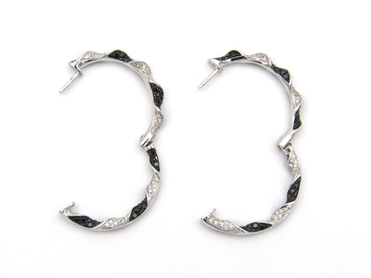 18K gold black and colourless diamond earrings.