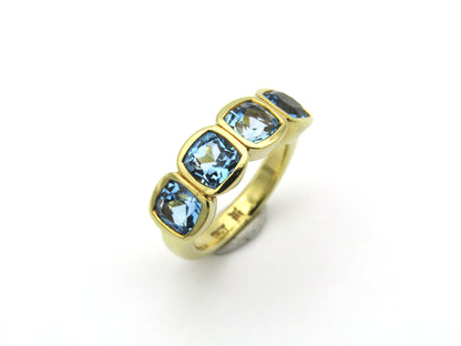18K gold blue topaz ring.