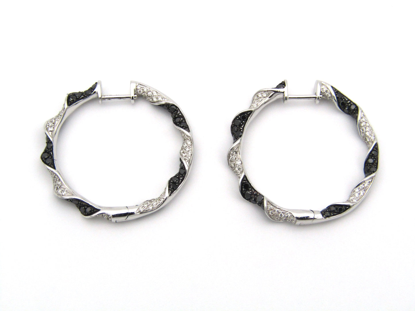 18K gold black and colourless diamond earrings.