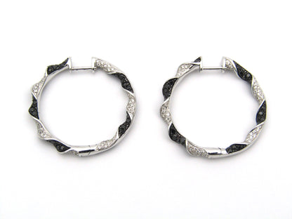 18K gold black and colourless diamond earrings.