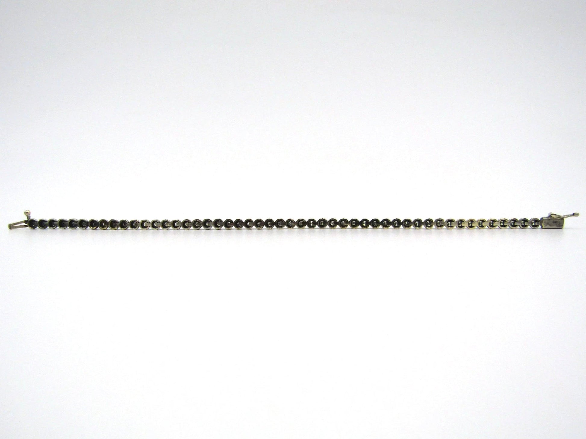 14K gold diamond tennis bracelet.