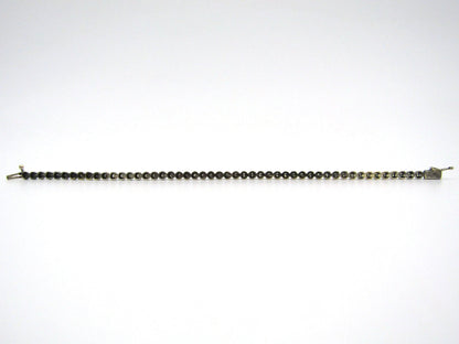 14K gold diamond tennis bracelet.