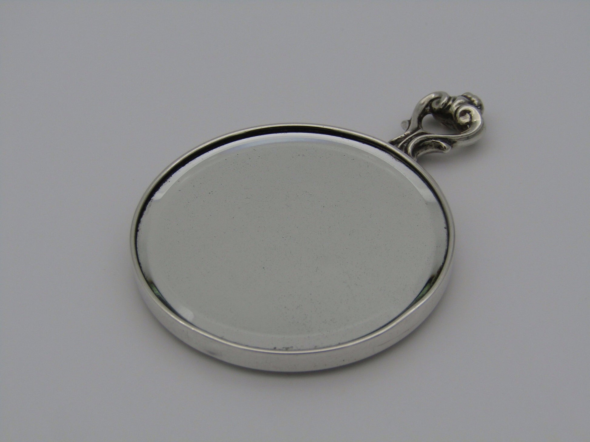 A sterling silver hand mirror by Cartier. Circa 1920s.