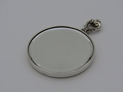 A sterling silver hand mirror by Cartier. Circa 1920s.