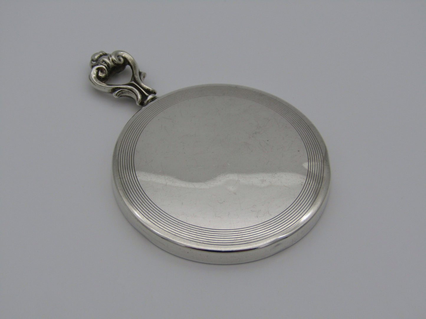 A sterling silver hand mirror by Cartier. Circa 1920s.