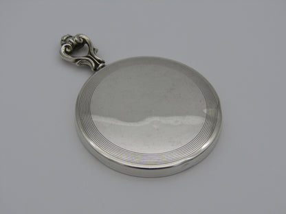 A sterling silver hand mirror by Cartier. Circa 1920s.