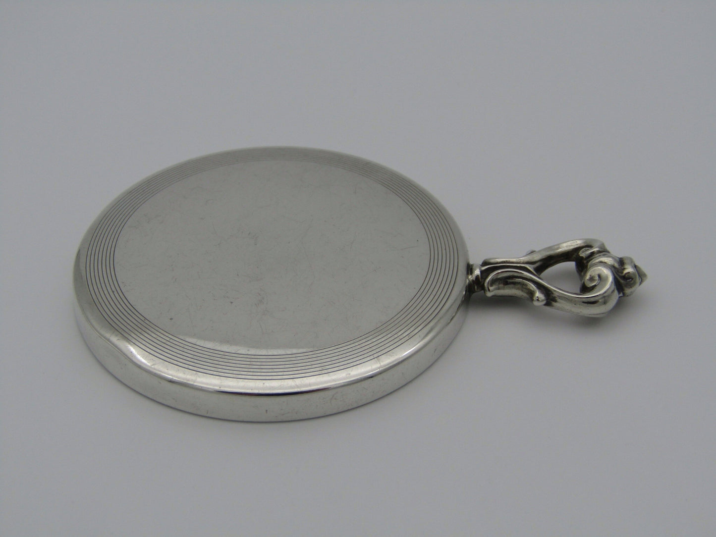 A sterling silver hand mirror by Cartier. Circa 1920s.
