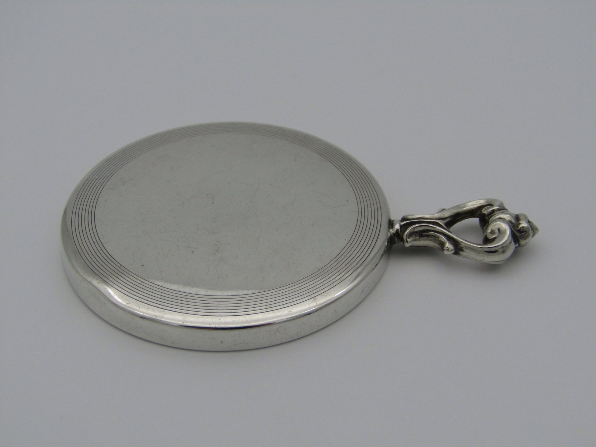 A sterling silver hand mirror by Cartier. Circa 1920s.